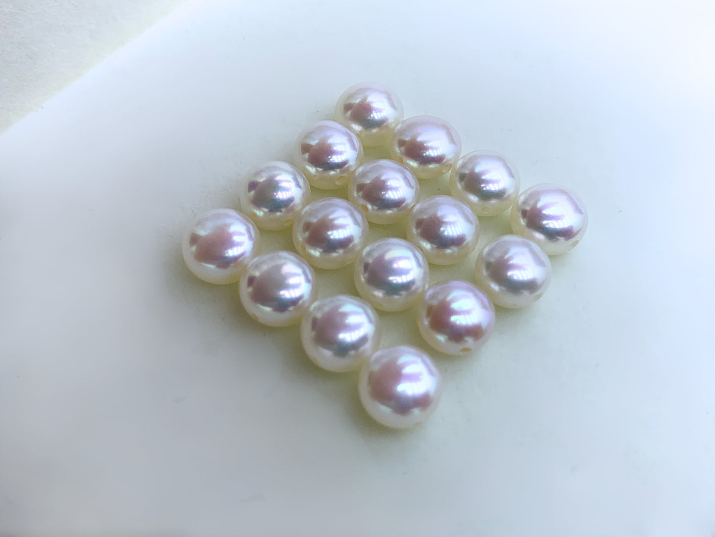 Close-up of AAA-grade button pearls with pink luster, ideal for bracelets and necklaces