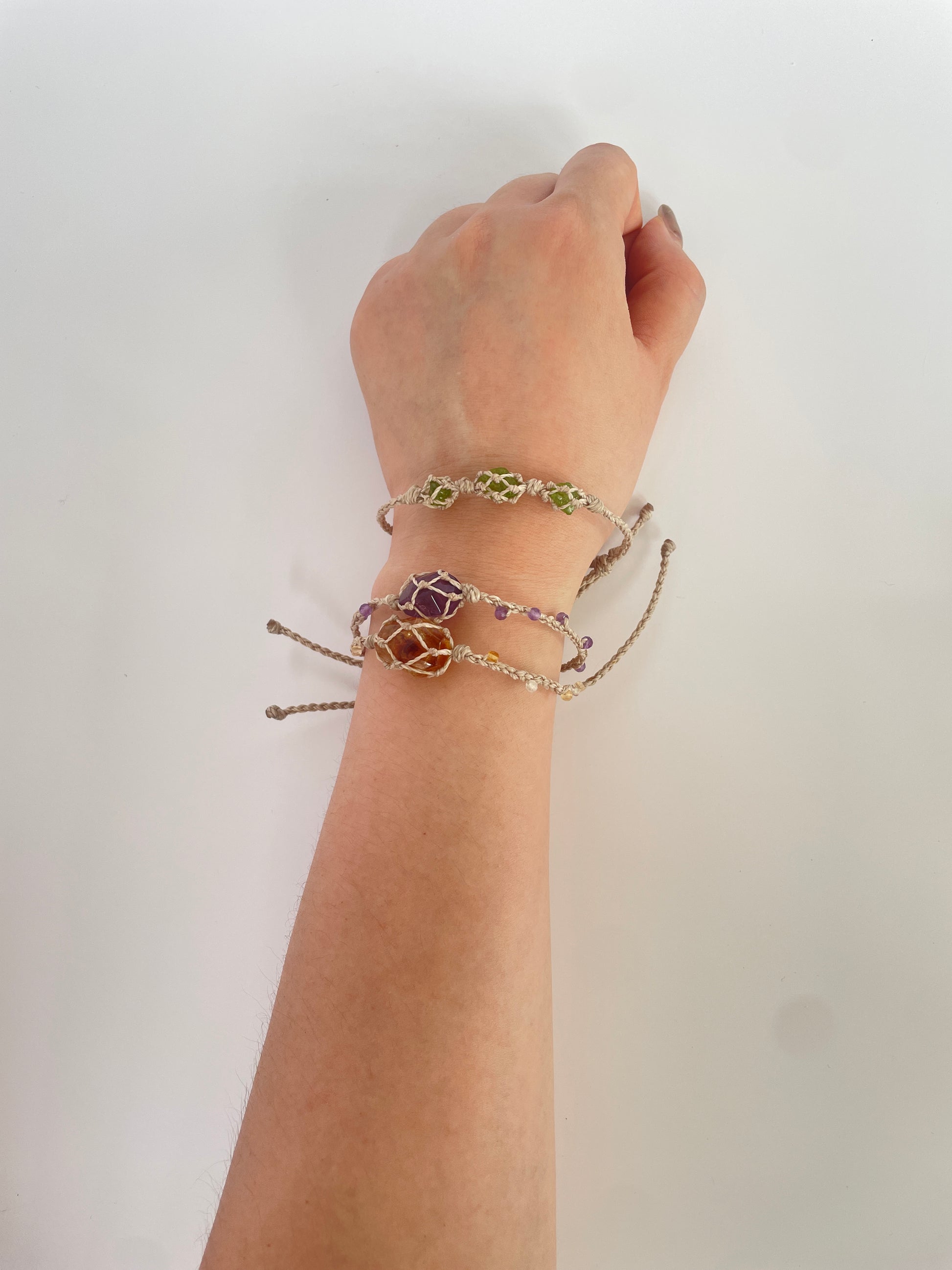 Side view of crystal healing bracelet featuring Peridot, Amethyst, and Citrine for spiritual energy.