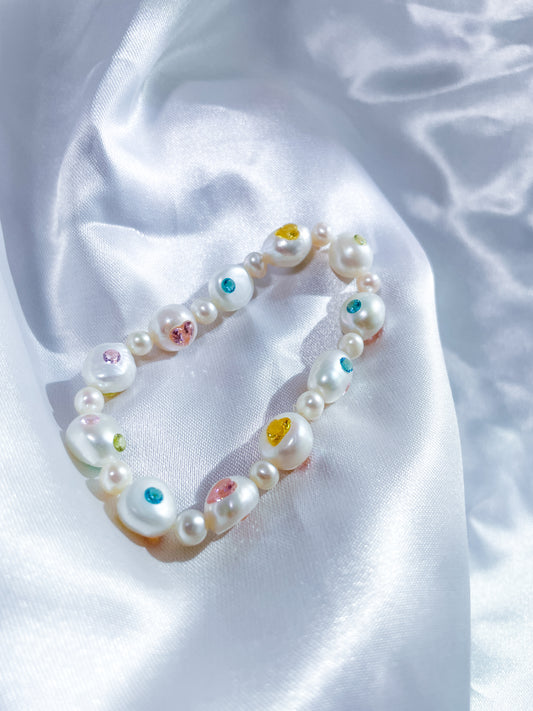 Handcrafted freshwater pearl bracelet with pink heart-shaped zircon accents and AAA-grade natural pearls.