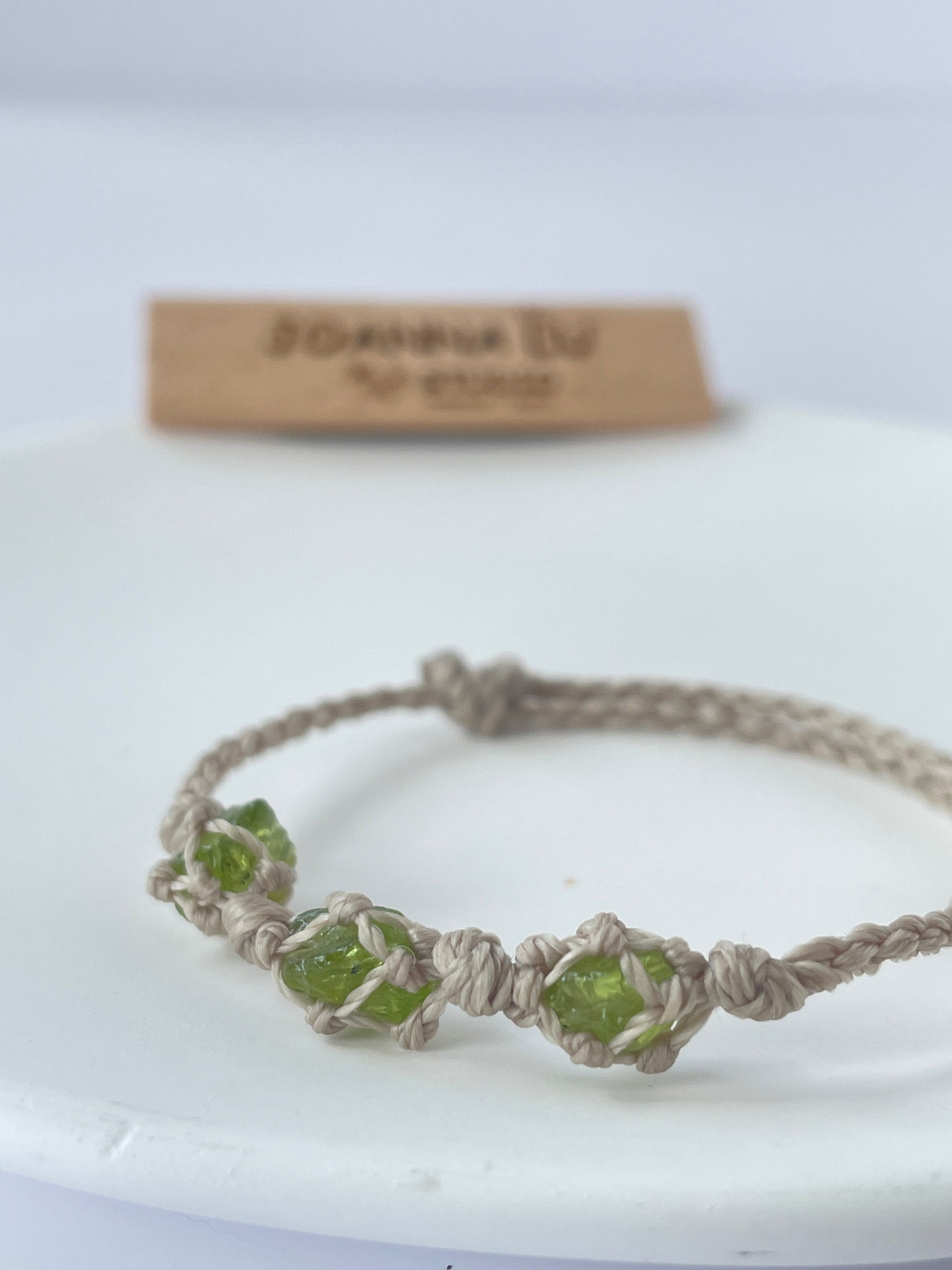 Close-up of Peridot crystal bracelet for emotional balance and harmony, handmade with adjustable wax cord.