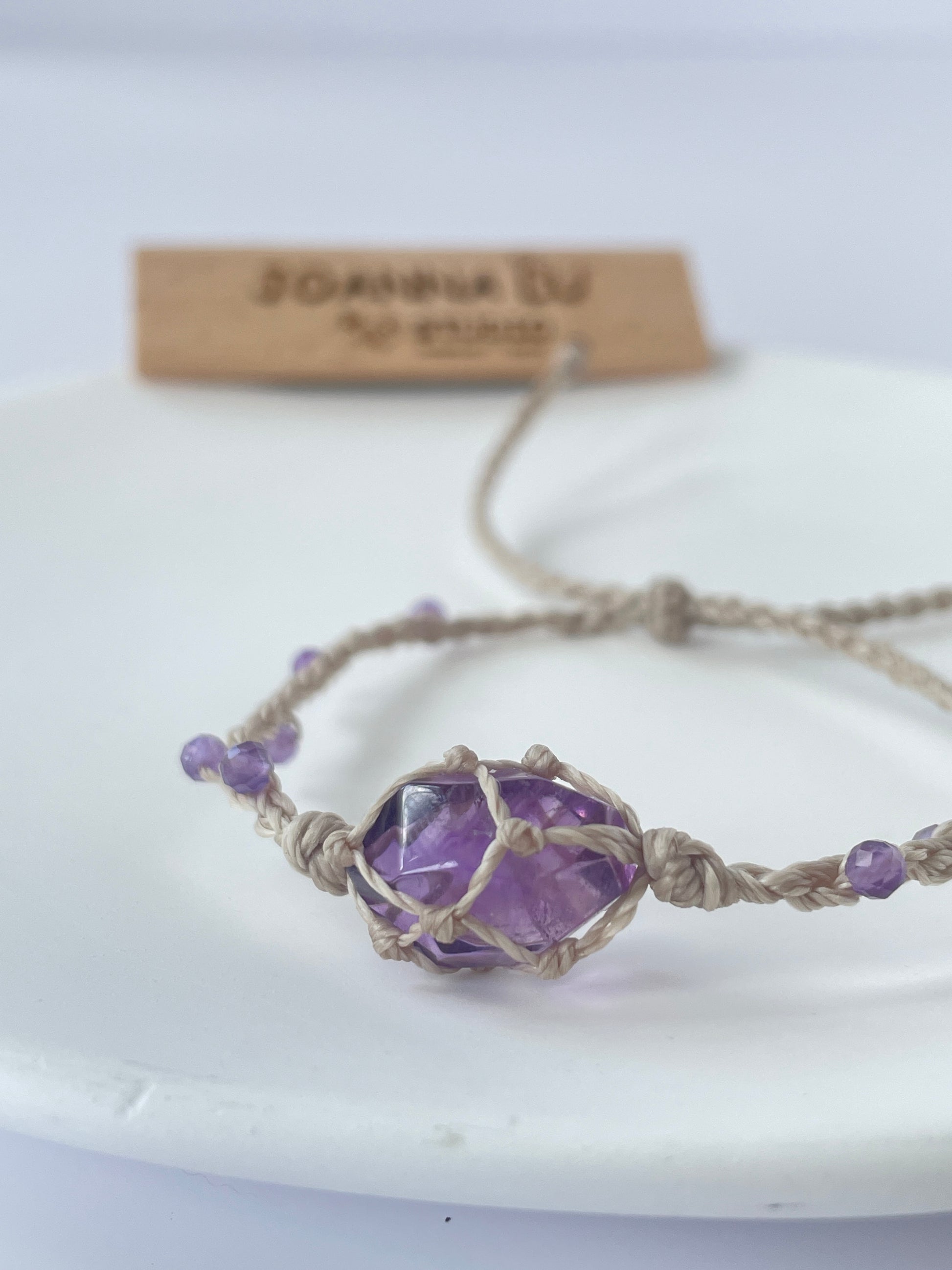 Close-up of Amethyst crystal healing bracelet for calmness and spiritual growth, featuring durable wax cord.