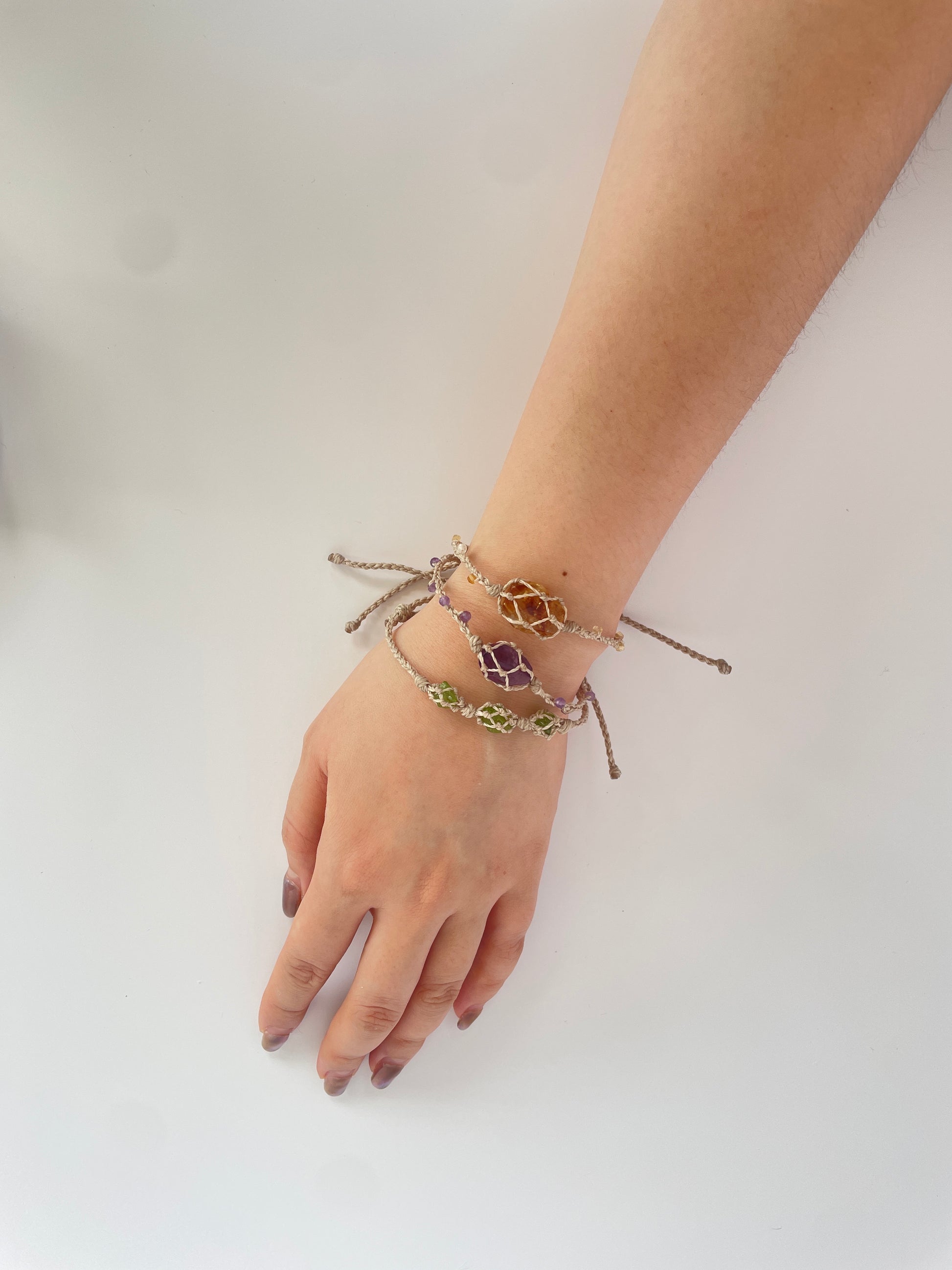 Model wearing handmade crystal bracelet with Citrine, Amethyst, and Peridot, perfect for daily wear.