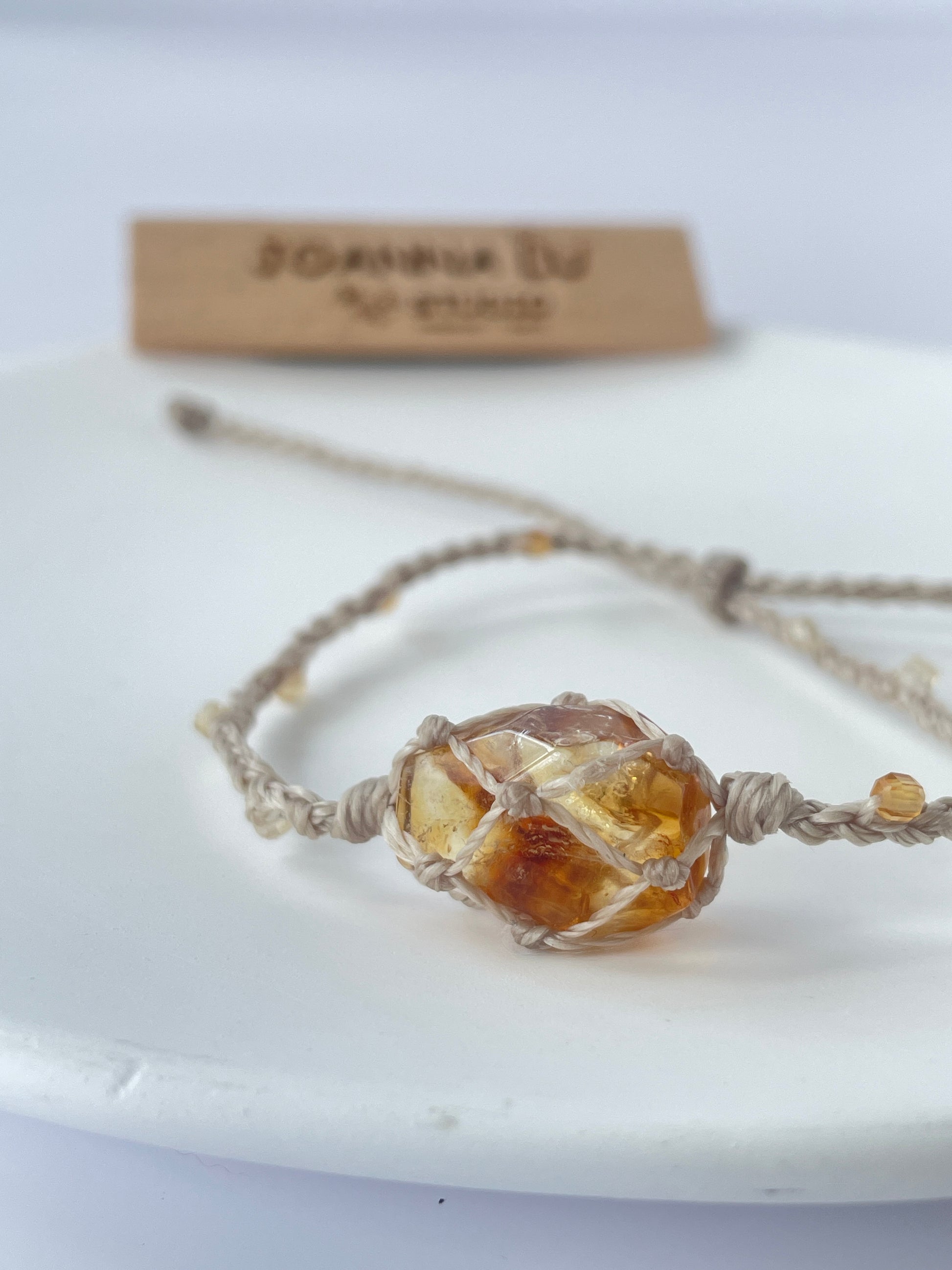 Close-up of handmade Citrine healing bracelet with adjustable Brazilian wax cord for energy and abundance.