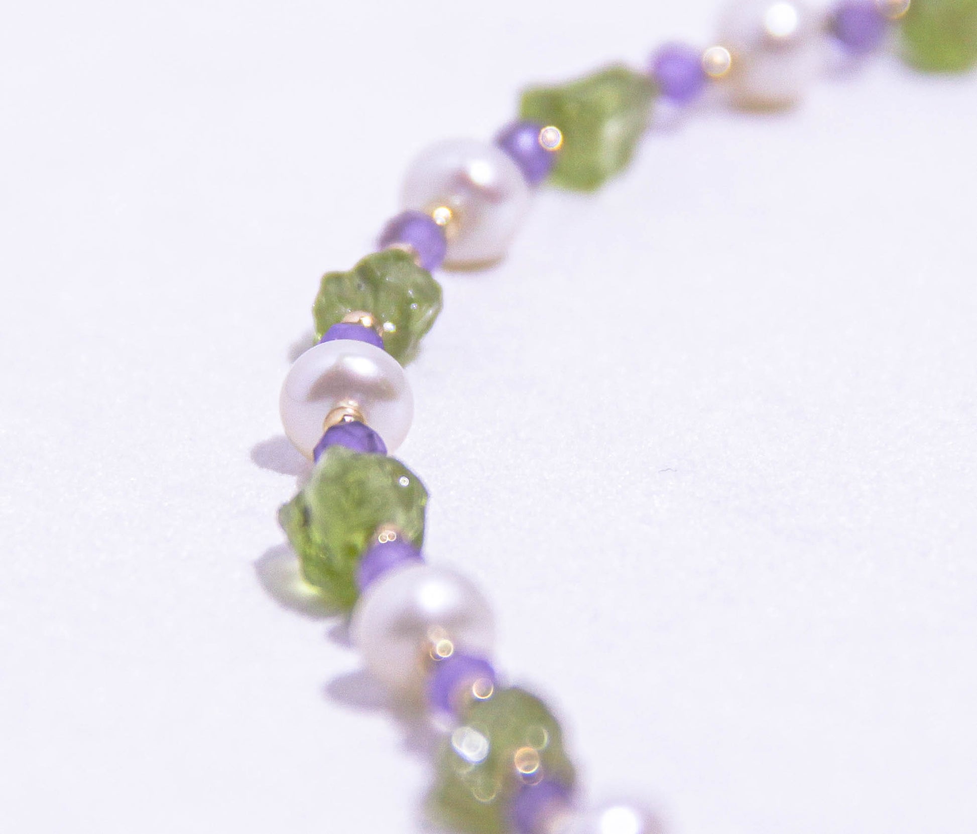Handcrafted gemstone choker necklace with green Peridot, purple Amethyst, and radiant pearls