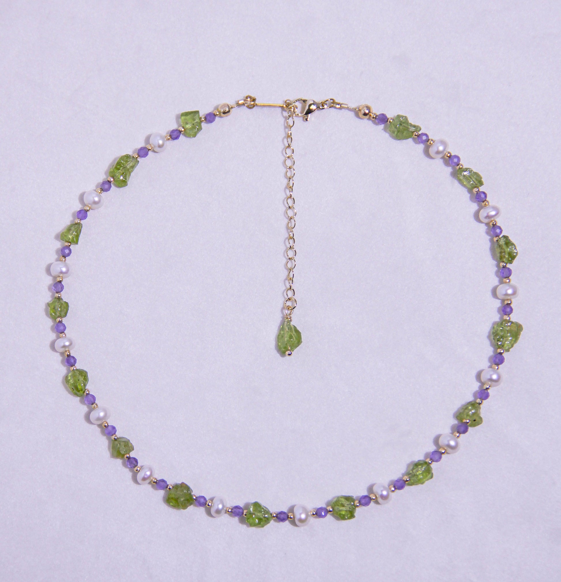 legant Peridot and Amethyst crystal necklace styled for August birthdays and meditation practices