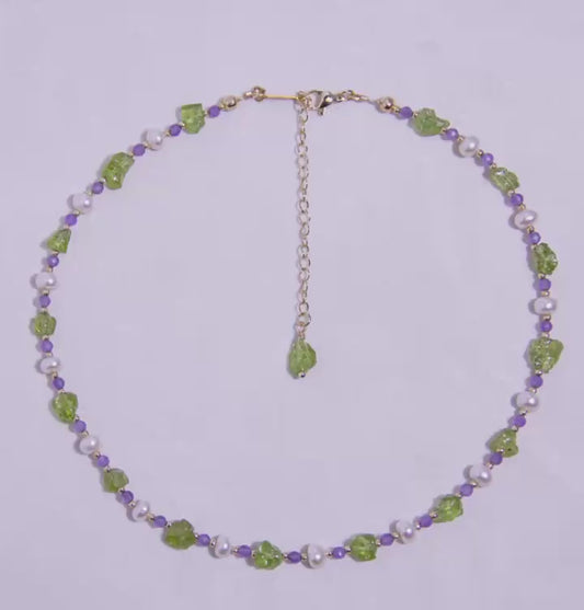 Handmade Peridot Amethyst Pearl necklace with 18K gold-plated adjustable chain, displayed in a circular design
